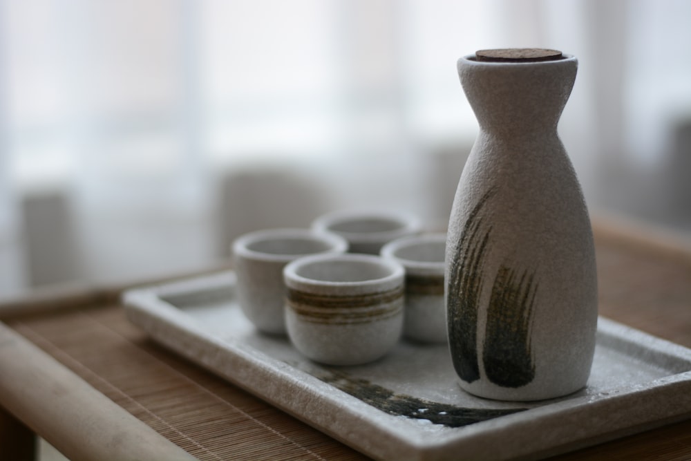white ceramic vase on white wooden tray