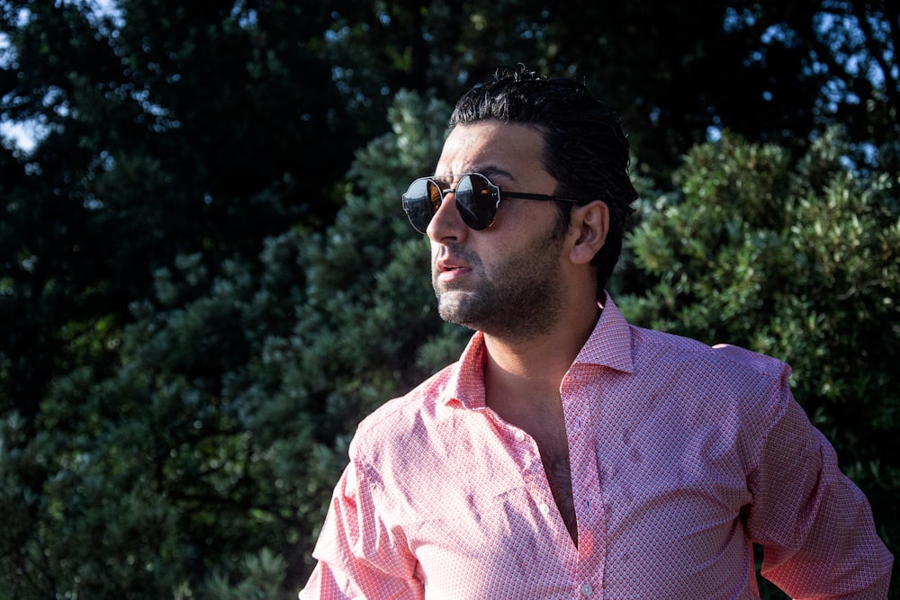 man in pink and white checkered button up shirt wearing black sunglasses