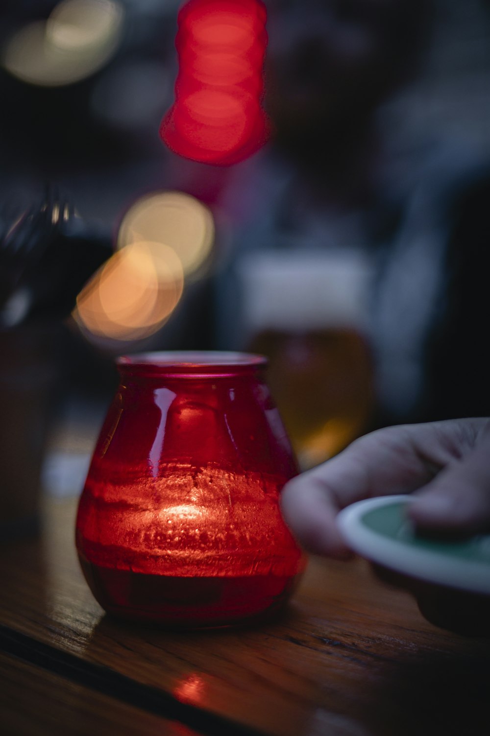 red glass jar with red liquid