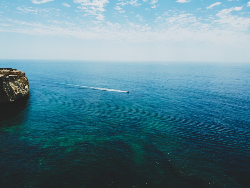 blue sea under blue sky and white clouds during daytime