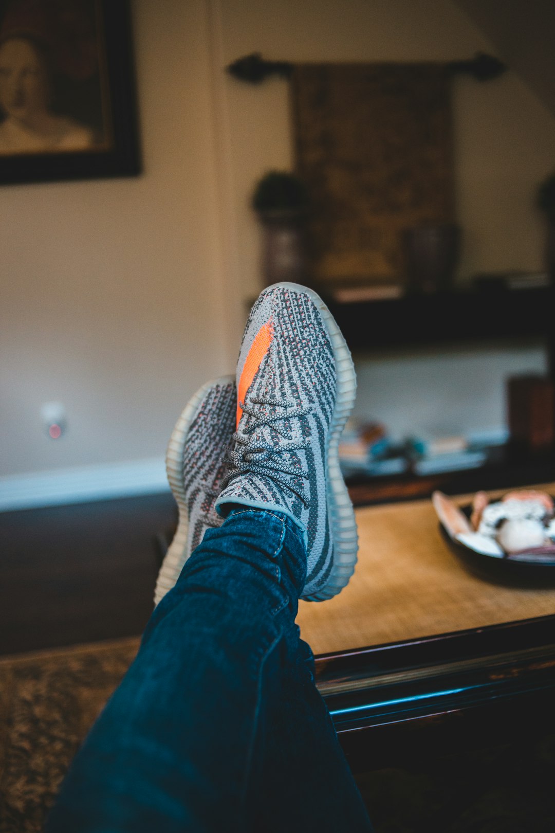 person wearing blue denim jeans and gray and white sneakers