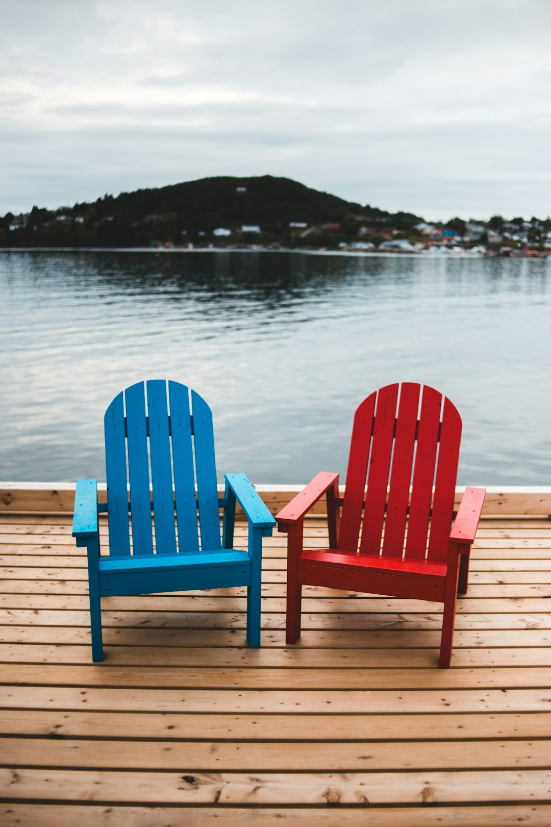 red and blue striped wooden chair on dock