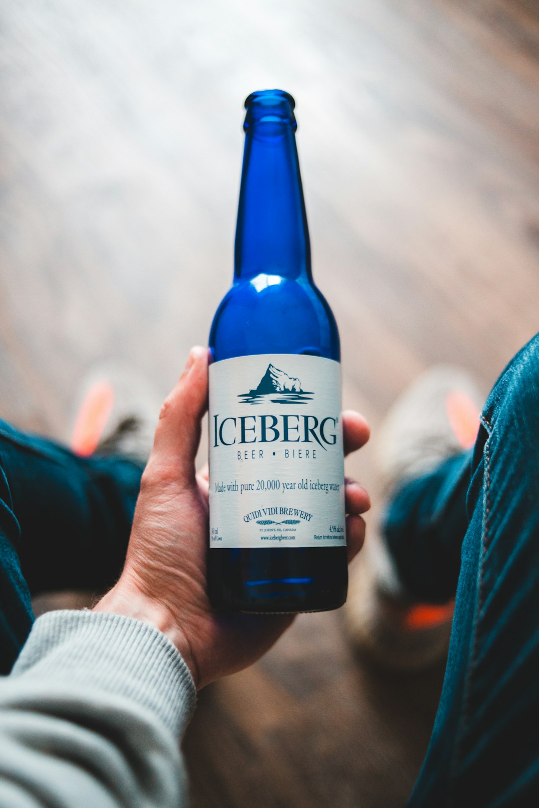 person holding blue and white labeled bottle