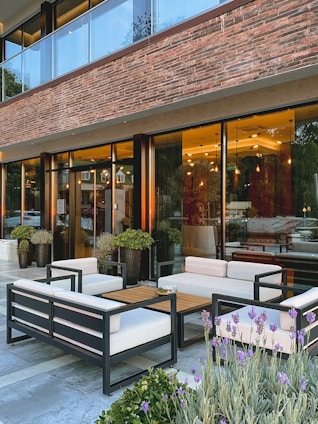 An exterior view of a modern co-working space with outdoor seating.