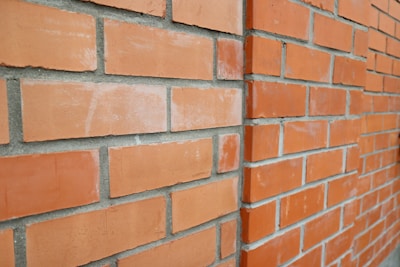 Close-up of a freshly built brick wall showcasing precise masonry work under natural daylight.