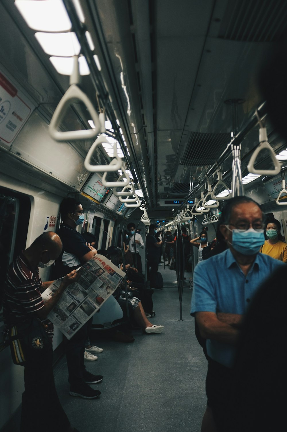 man in blue polo shirt sitting on train seat