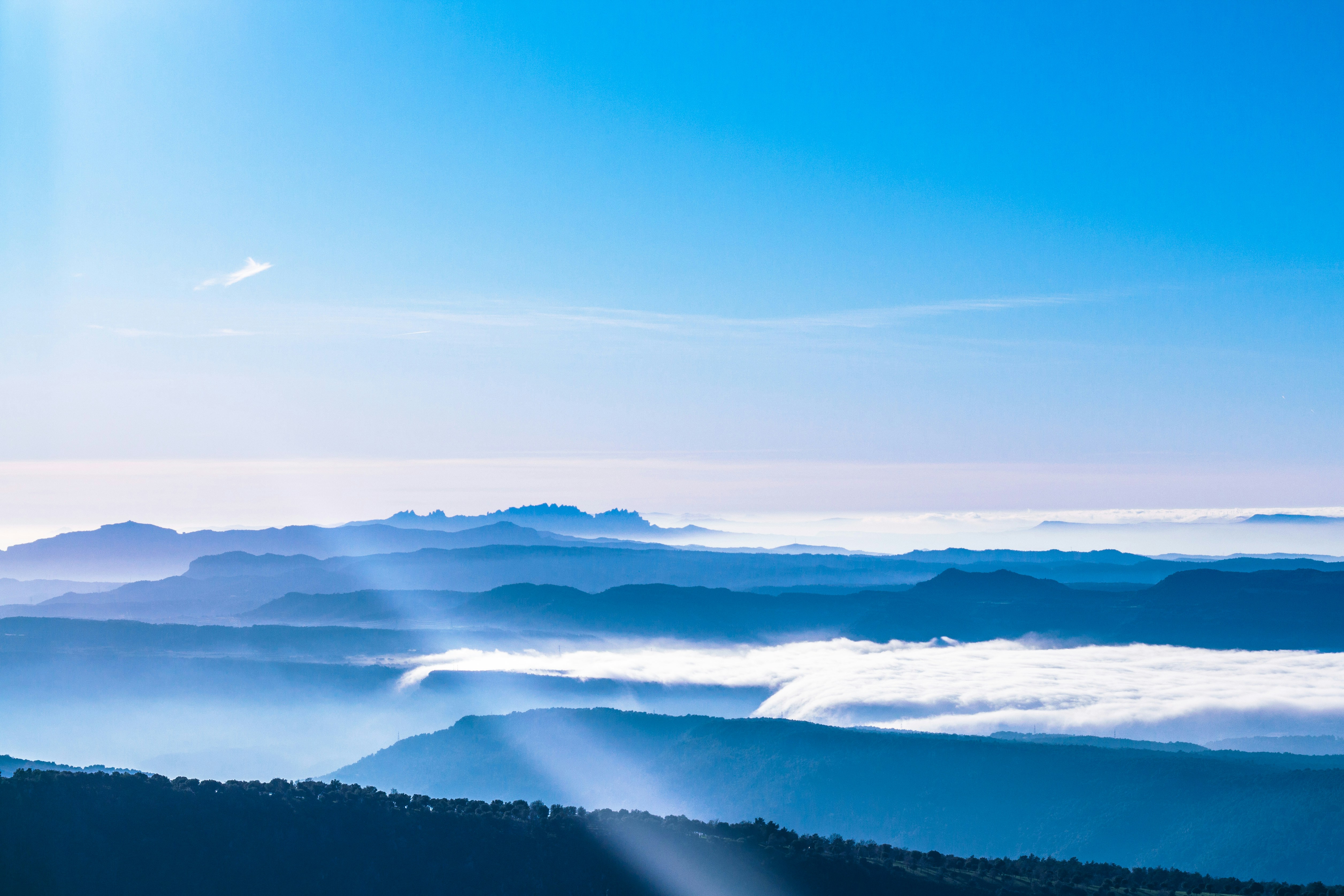 white clouds over green mountains