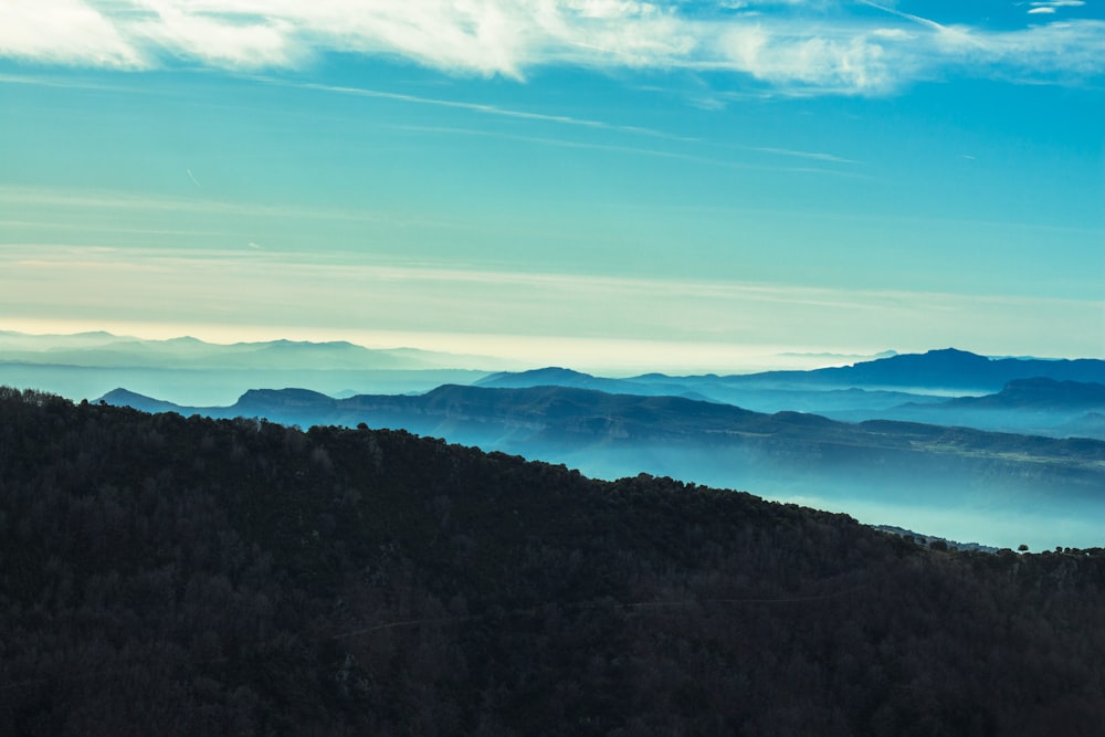 aerial view of mountains and clouds during daytime