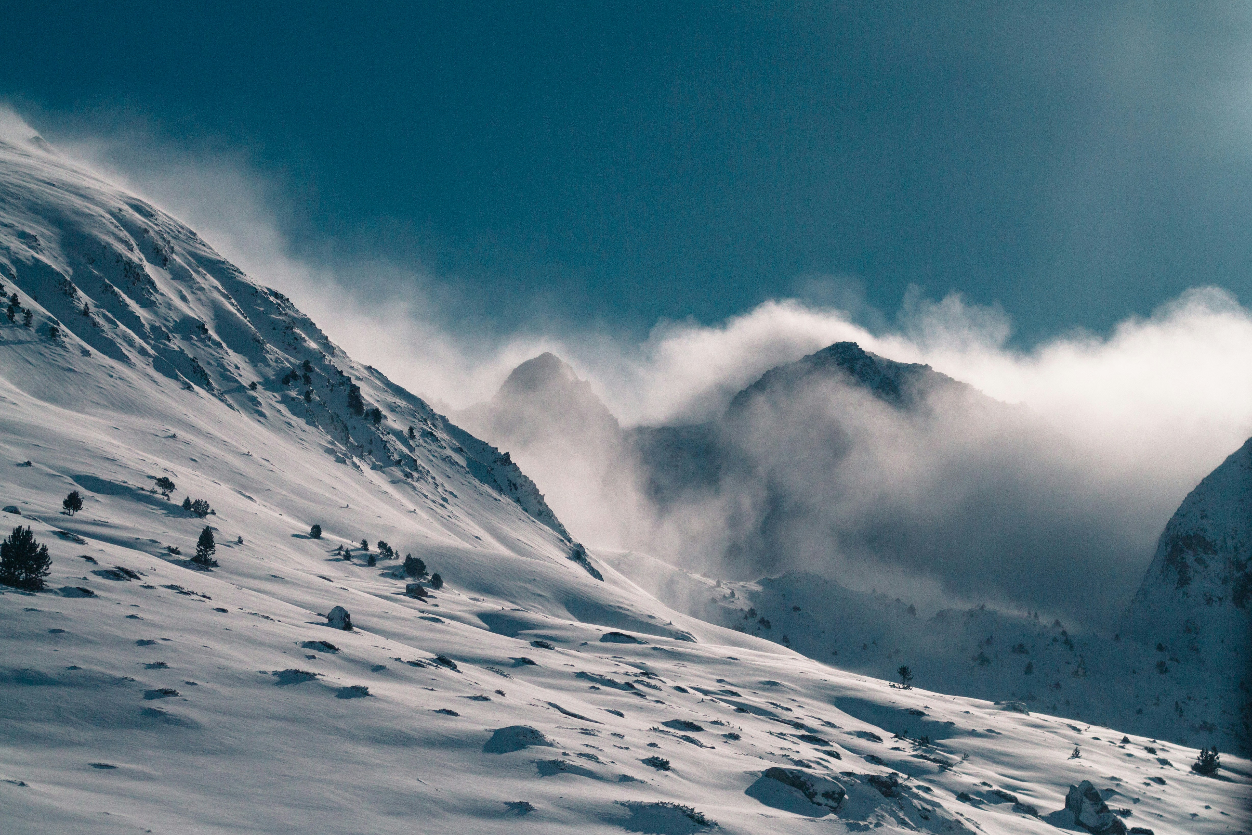 snow covered mountain under blue sky during daytime