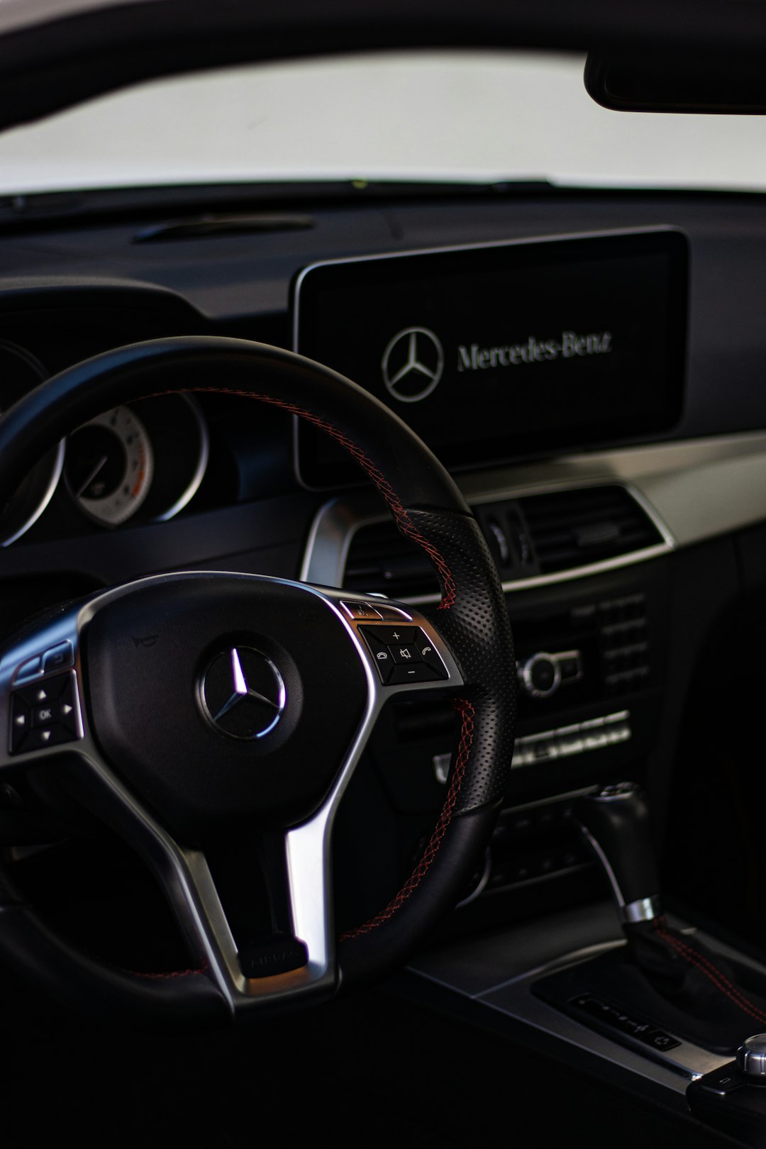 black and silver mercedes benz steering wheel