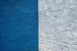 blue concrete wall with white paint