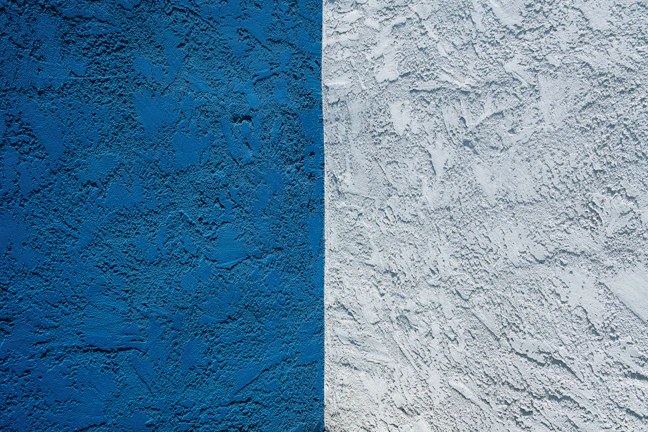 blue concrete wall with white paint