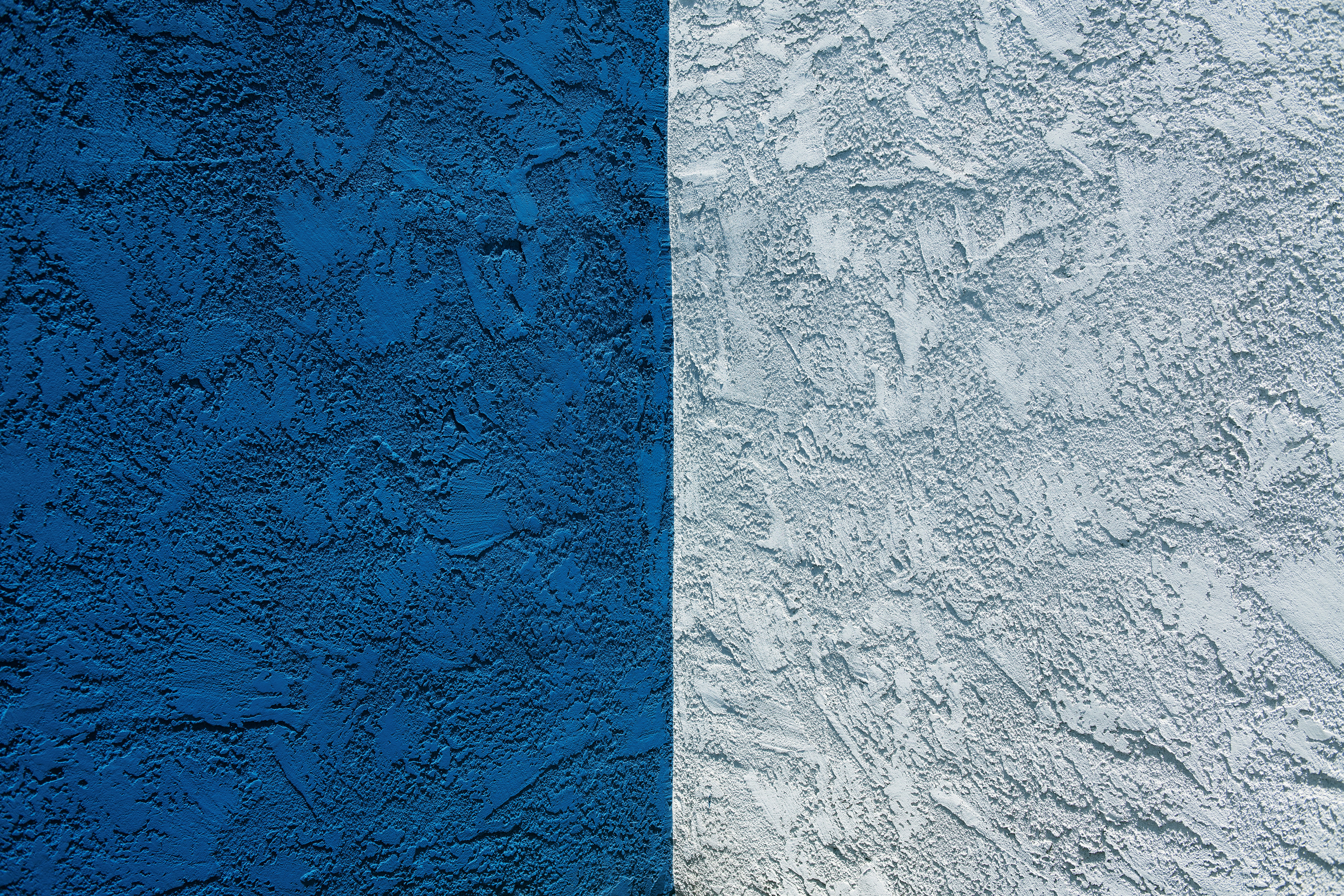 blue concrete wall with white paint