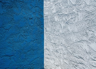 blue concrete wall with white paint