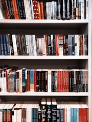 books on white wooden shelf
