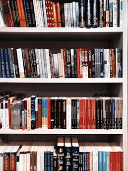 books on white wooden shelf