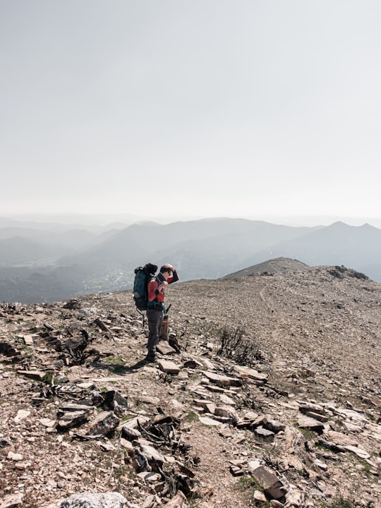 man in black jacket standing on rocky hill during daytime in Salvergues France