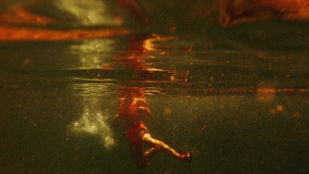 woman in red dress floating on water