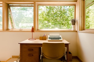 silver macbook pro on brown wooden desk