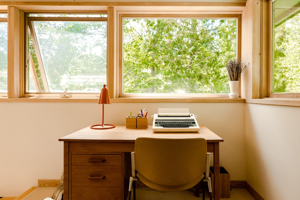 silver macbook pro on brown wooden desk