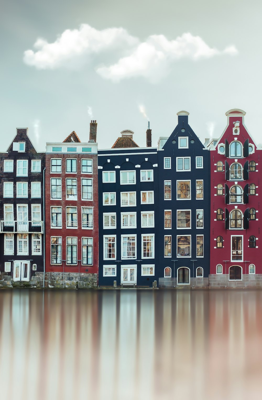 red and white concrete building near body of water