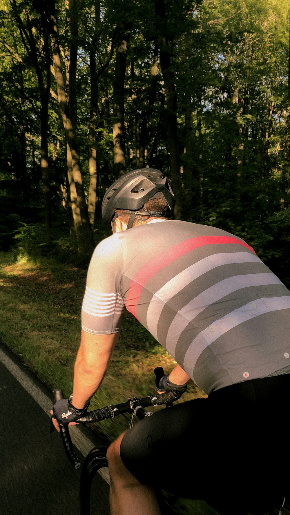 person in white and black stripe shirt wearing helmet