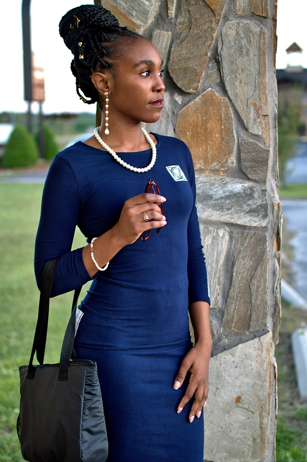 woman in blue long sleeve shirt wearing gold necklace