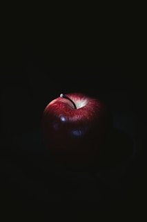 red apple on black surface