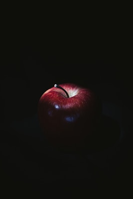 red apple on black surface