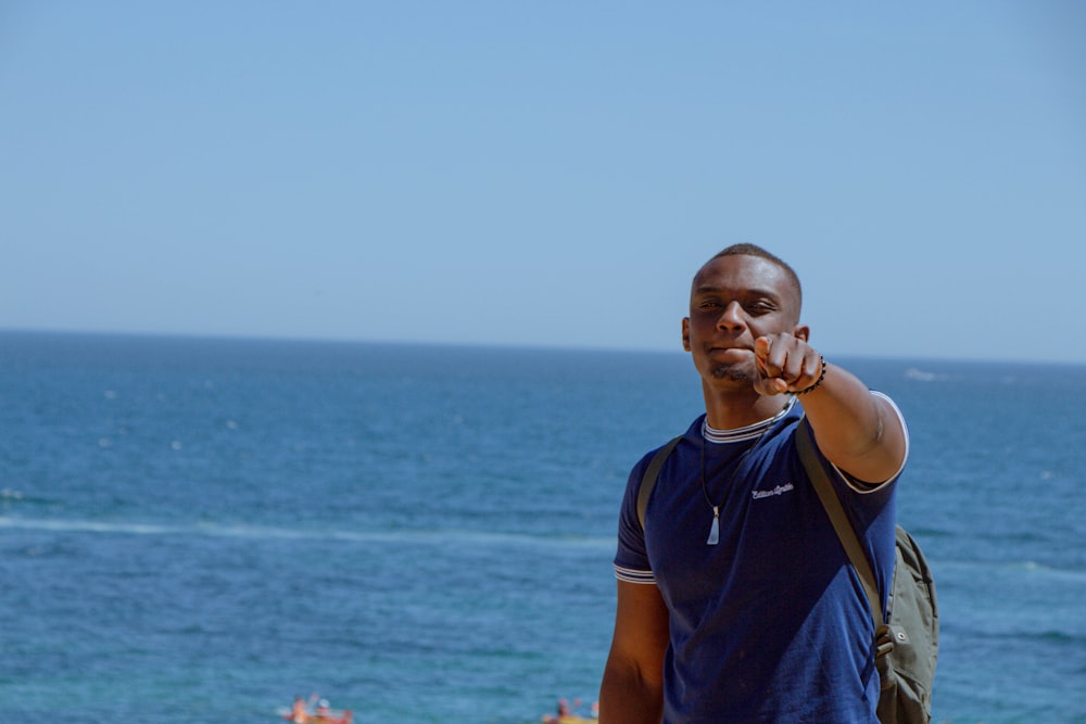 man in blue and yellow adidas crew neck t-shirt standing on boat during daytime