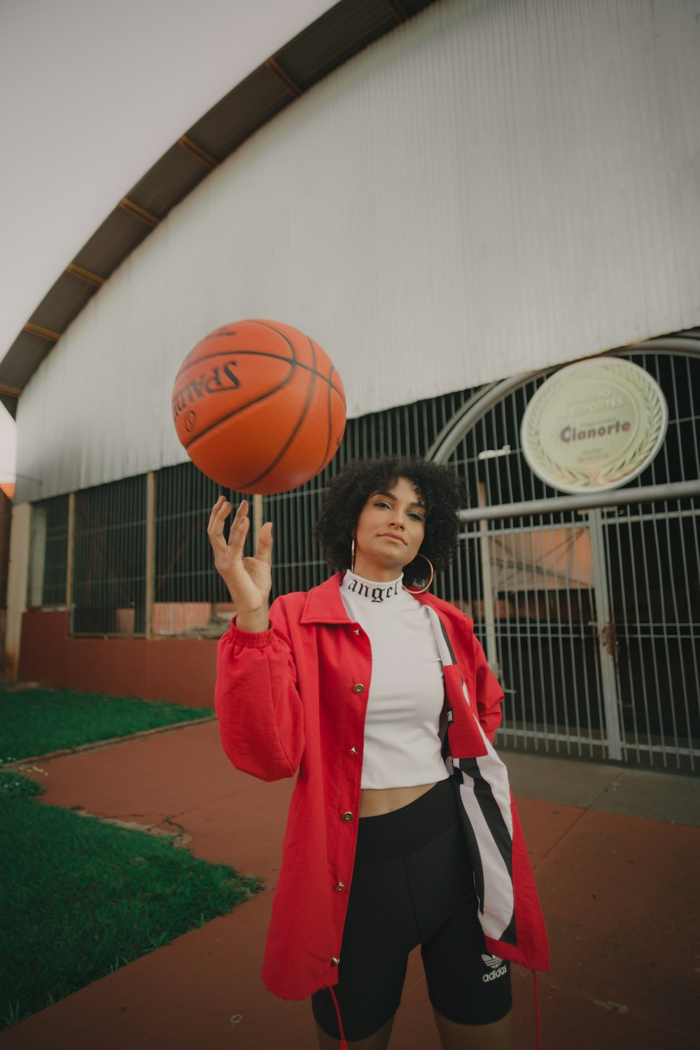 woman in red and white nike jersey holding basketball