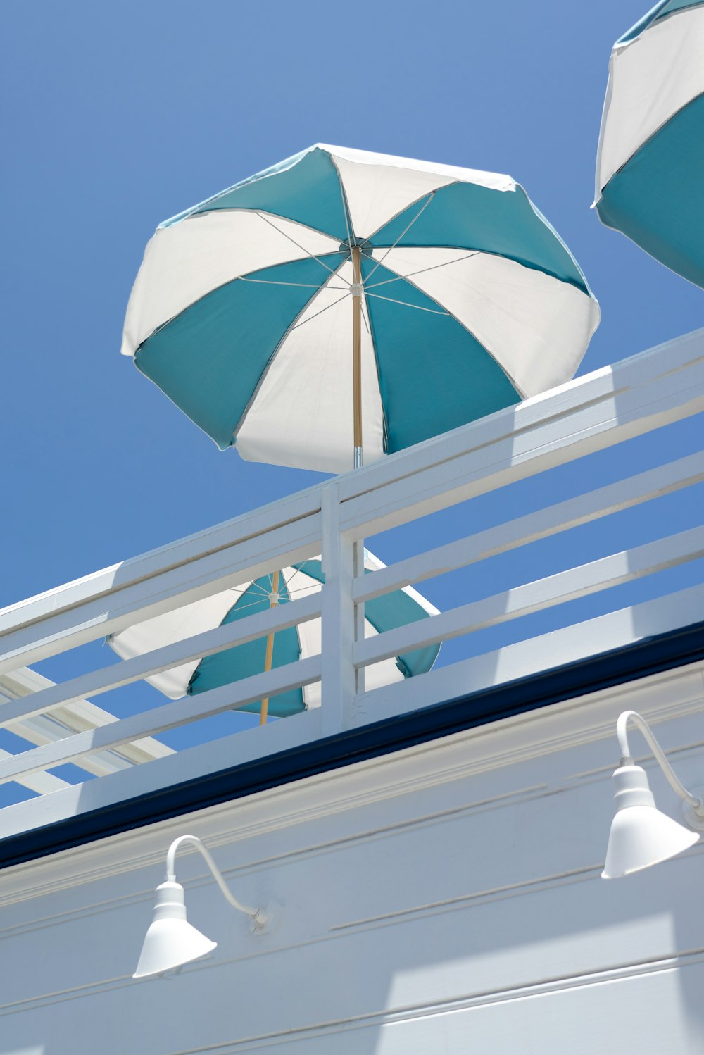 blue umbrella on white concrete building