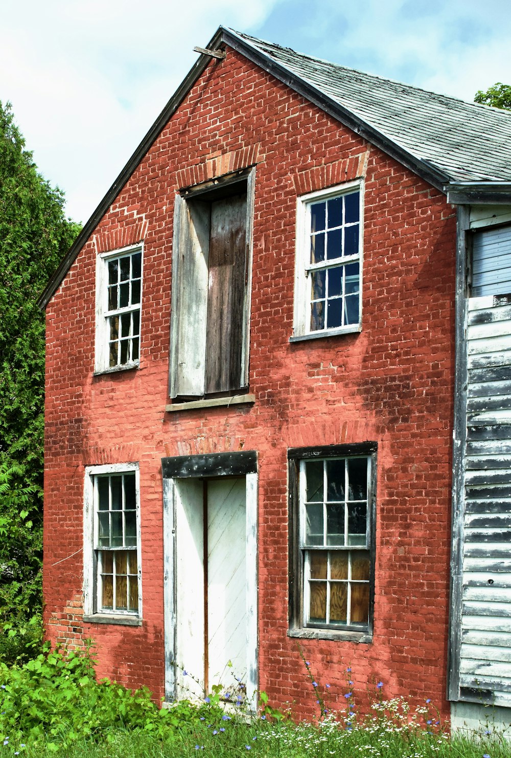 brown brick house with white wooden window