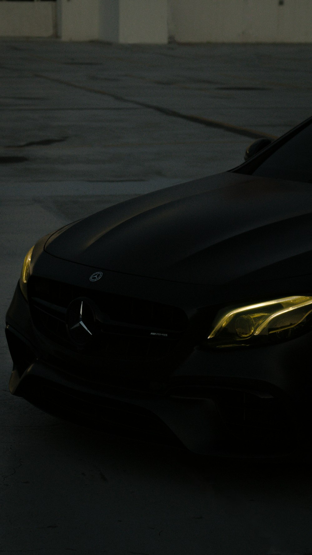 a close up of a black car in a parking lot