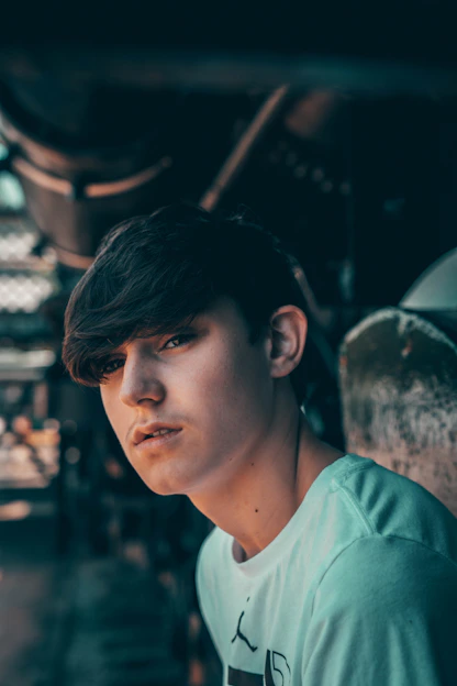 Portrait of Anthony Kannamma in a modern industrial setting with dark, cinematic lighting.