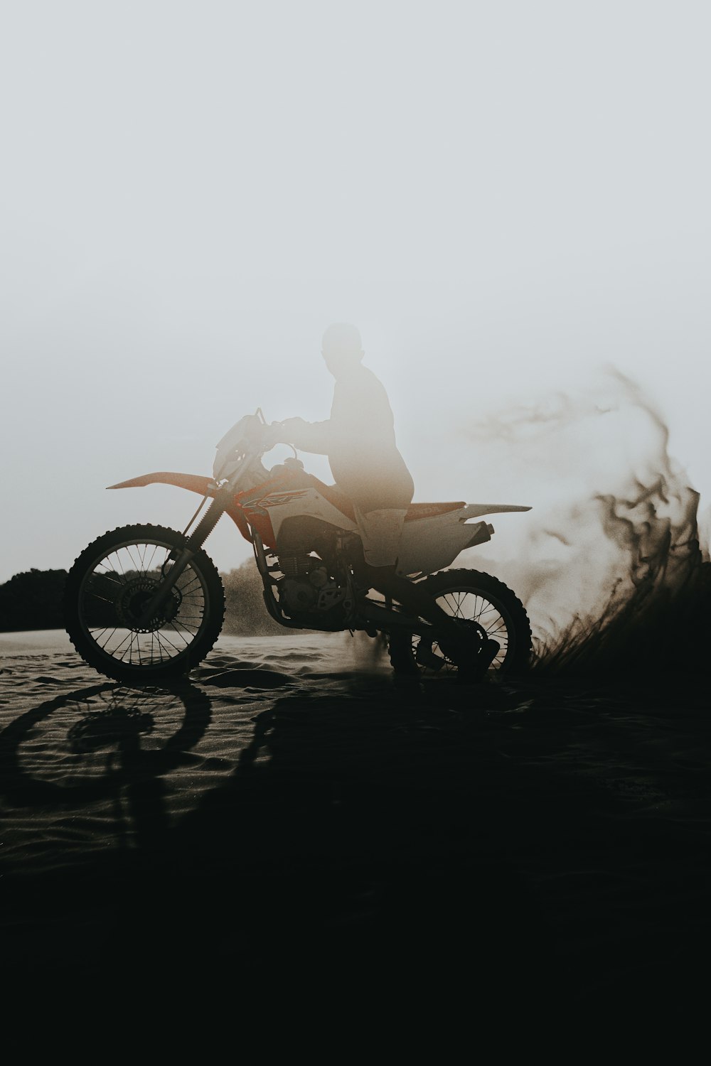 man riding motorcycle on beach during daytime