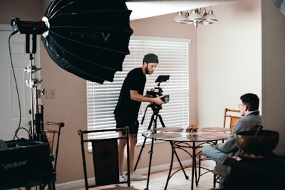 man in black t-shirt holding black umbrella