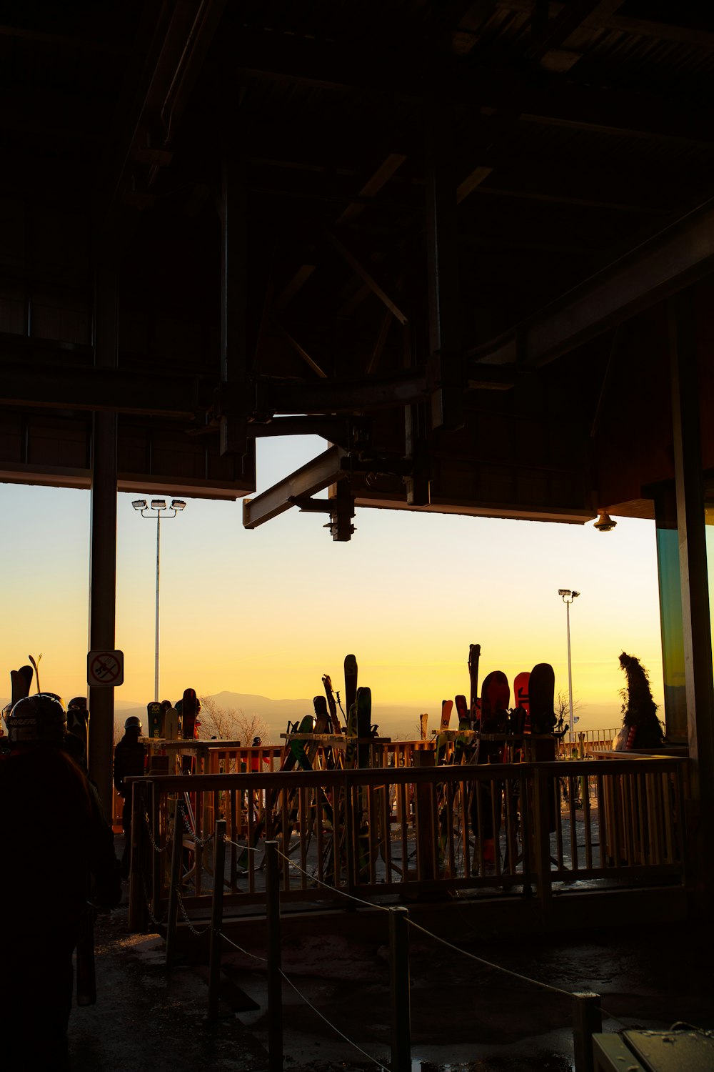 silhouette of people standing on balcony during sunset