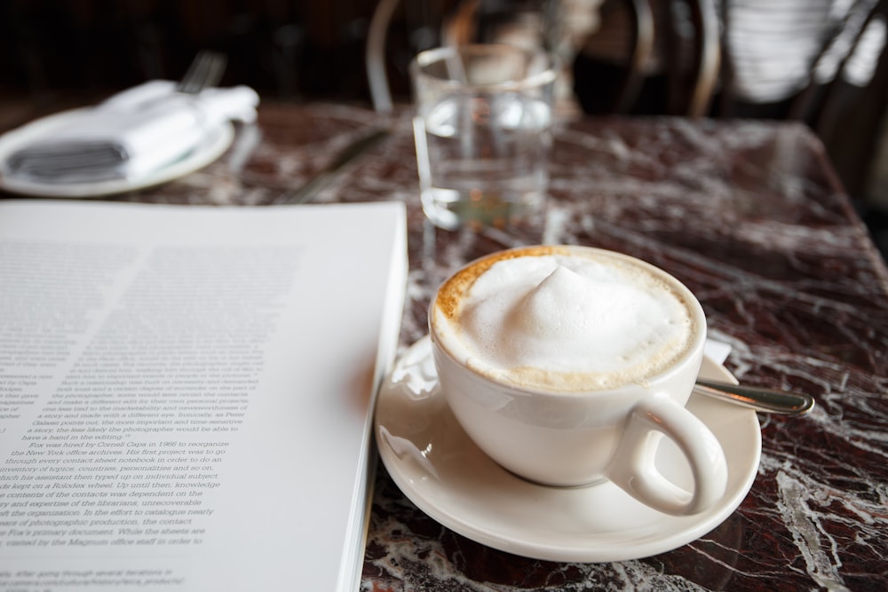 white ceramic teacup on white ceramic saucer