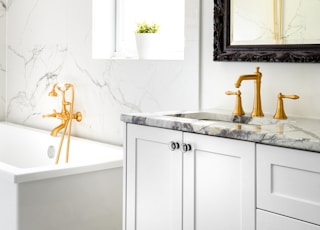 white ceramic bathtub with faucet