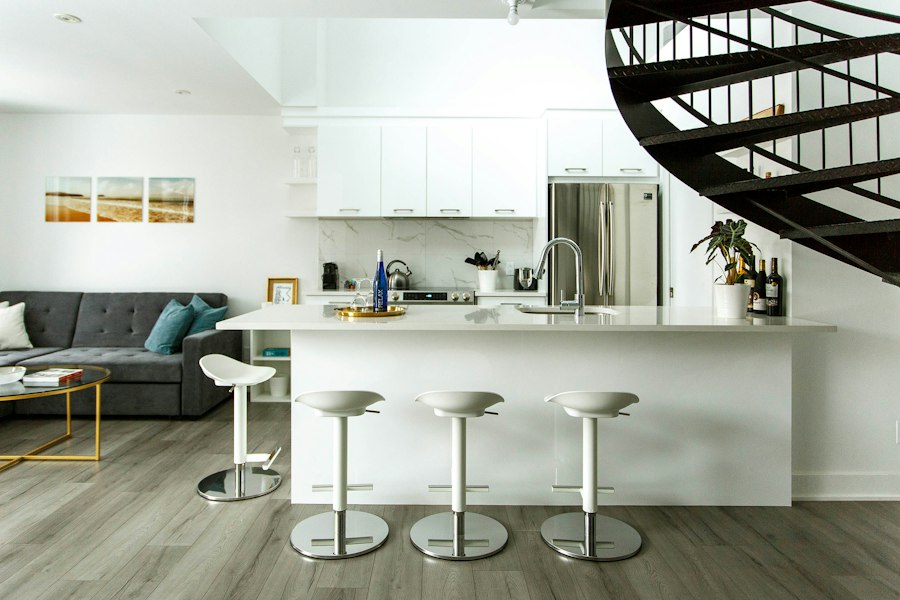 A kitchen with a pale laminate plank floor