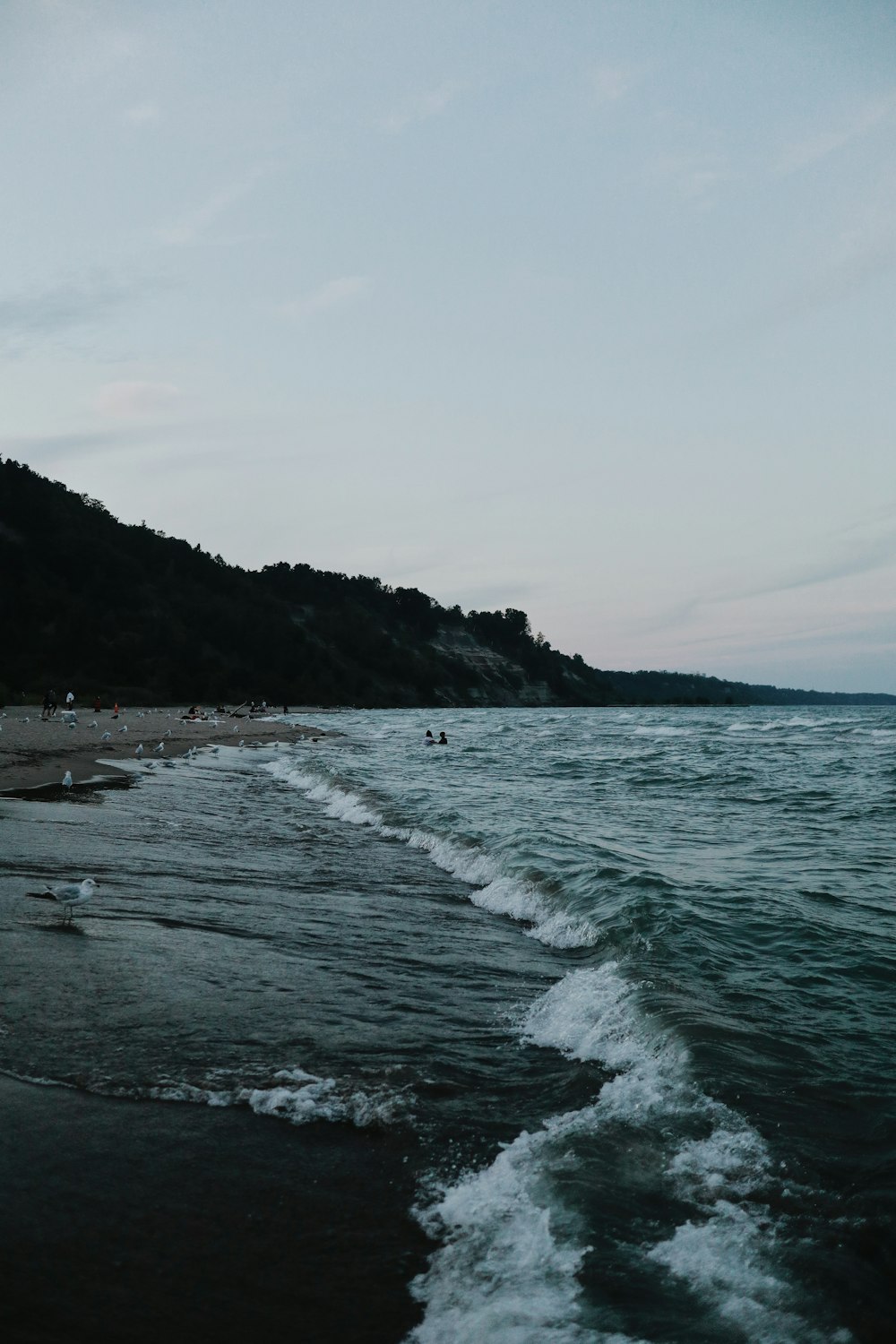 ocean waves crashing on shore during daytime