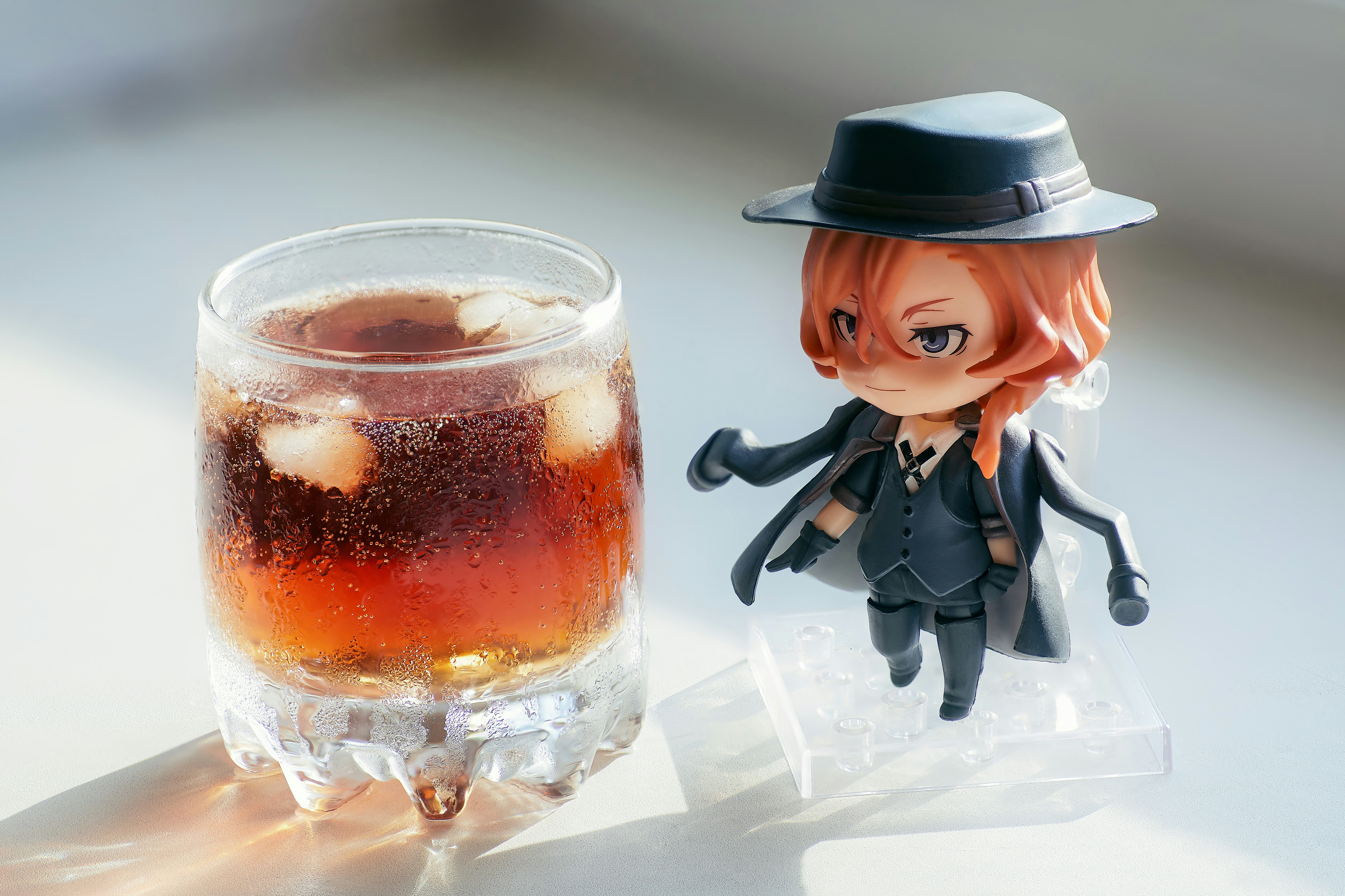 Nendoroid Chuya Nakahara - a close-up figure with a glass of whiskey and ice on a blurred background. Beautiful picture for your desktop and design with an anime character.