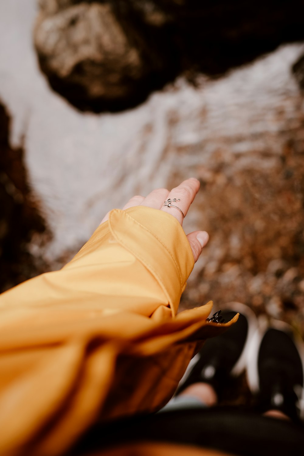 person in brown pants wearing silver ring