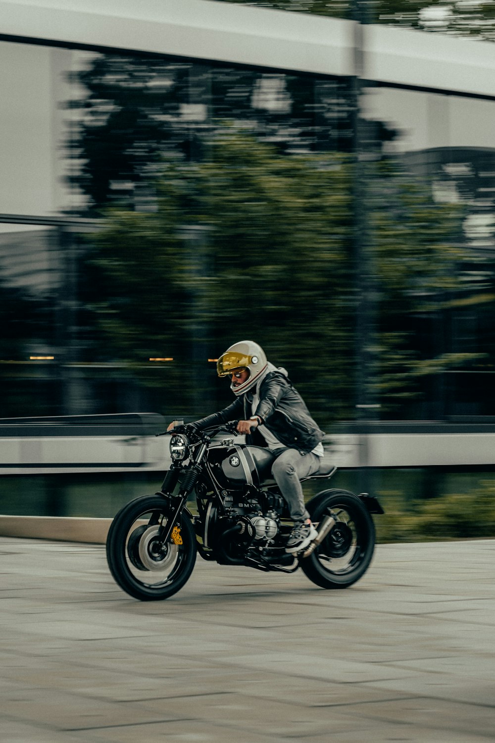 man in white helmet riding black motorcycle