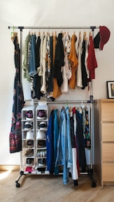 clothes hanged on brown wooden cabinet