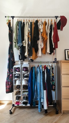 clothes hanged on brown wooden cabinet