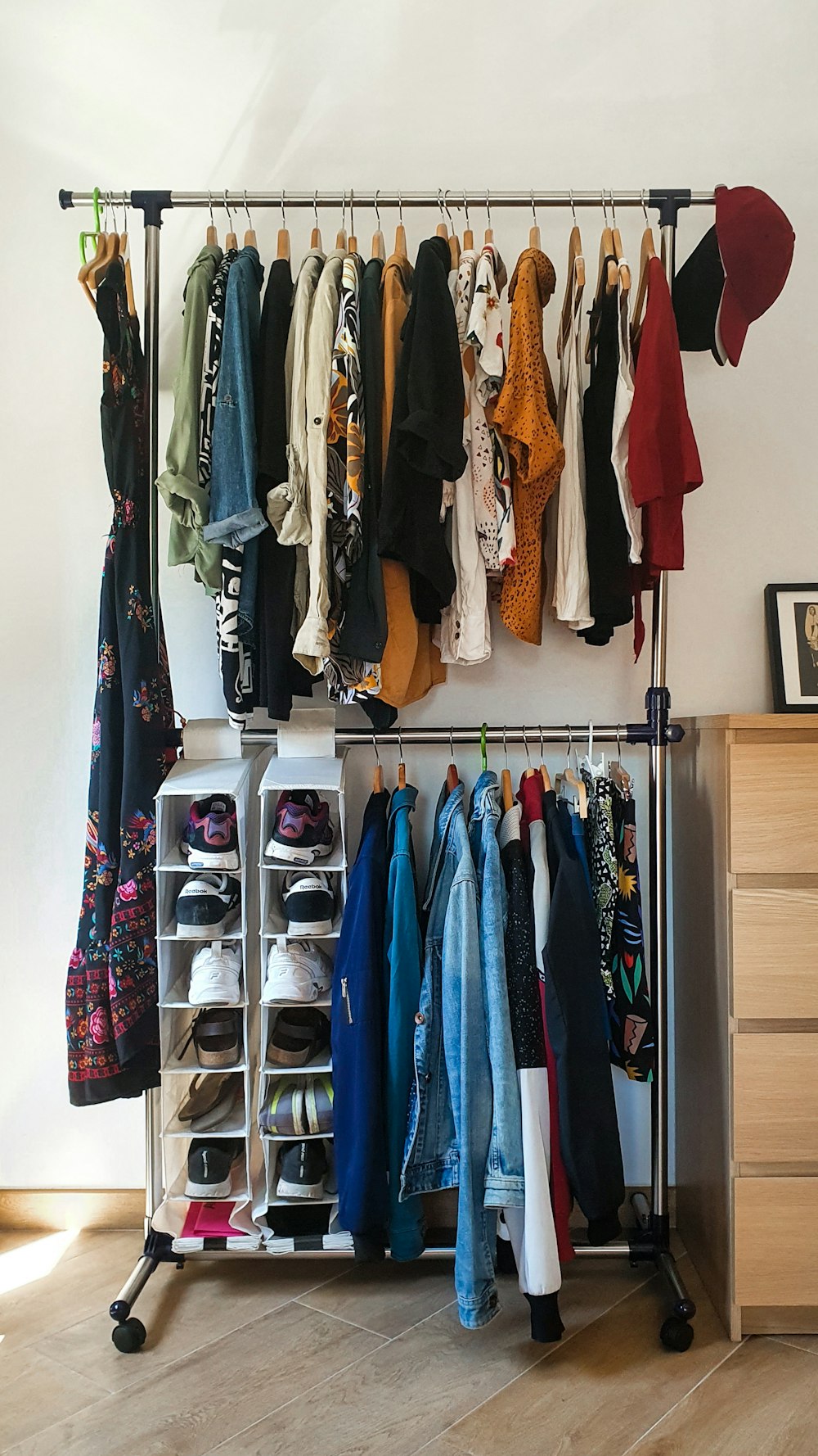 clothes hanged on brown wooden cabinet