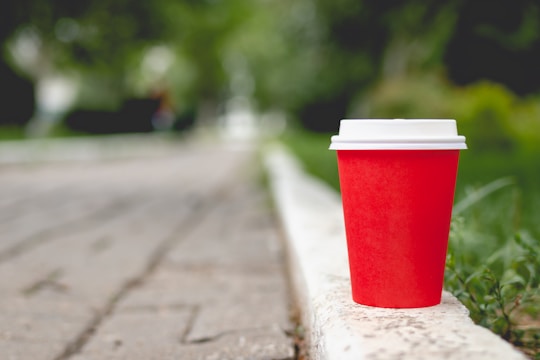 red and white plastic cup on gray concrete floor