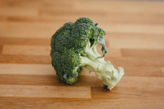 green broccoli on brown wooden table